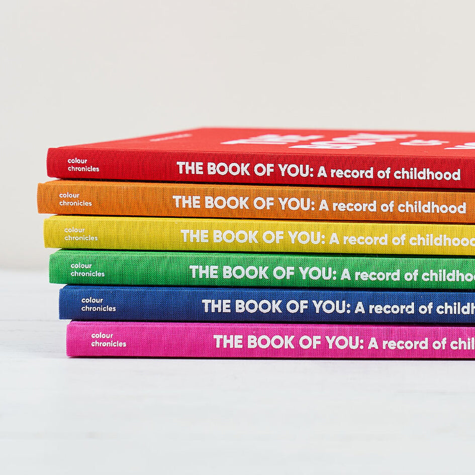 childhood memory journals shown in six bright rainbow colours